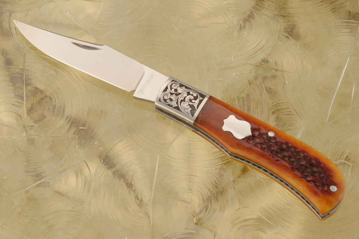 Engraved Trapper Slipjoint with Amber Jigged Bone - M390