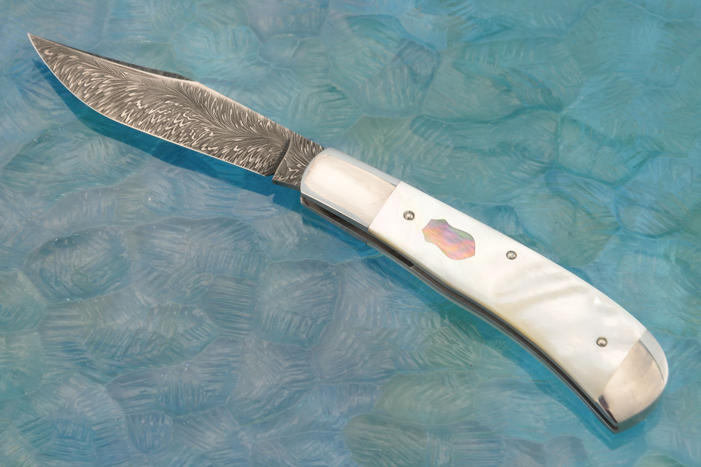 River of Fire Damascus Slipjoint Trapper with Whitelip and Blacklip Mother of Pearl